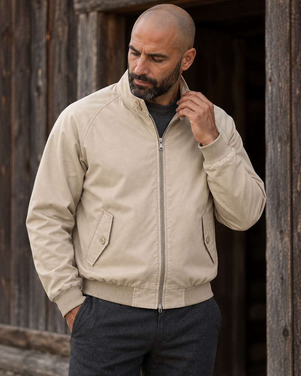 Man wearing the Harrington Jacket Timeless Refined at a timber cabin entrance